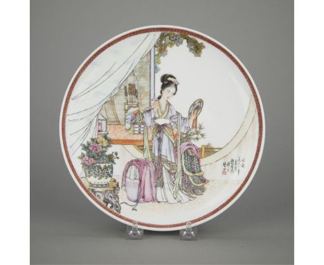 Chinese Republic period famille rose porcelain plate depicting a woman examining her reflection in a mirror, surrounded by sc