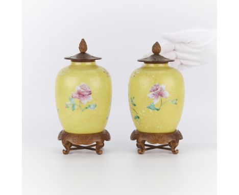 Pair of Chinese Guangzhou ceramic vases with carved wooden lids and stands, 20th century.(Each, with stand) height: 8 1/4 in 