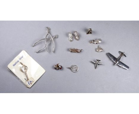 A quantity of silver and white metal charms - including aircraft, a train, old boots and a fire engine, total weight 41g.