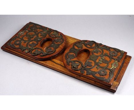 A Victorian walnut and brass mounted book trough - the pierced and engraved mounts decorated with flowers and foliage, bearin