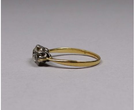 A three stone diamond ring - set in an 18ct yellow gold band, size P/Q, weight 2.9g.