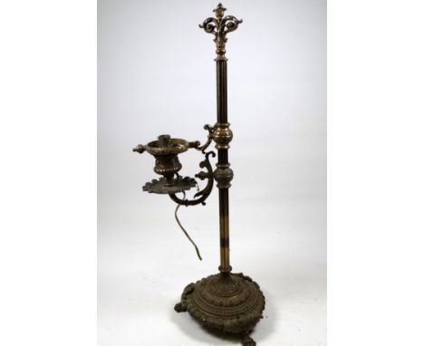 An early 20th century brass bouillotte table lamp - with a reeded column and cast circular base raised on four feet, height 4