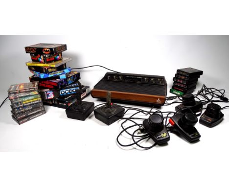 A vintage Atari video computer system - with two joystick controllers and four paddle controllers, games include Air Sea Batt