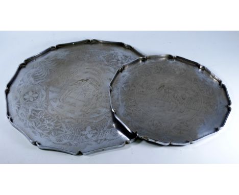 Two oriental white metal trays - decorated with figures in a garden, flowers and foliage, largest diameter 50.5cm. 