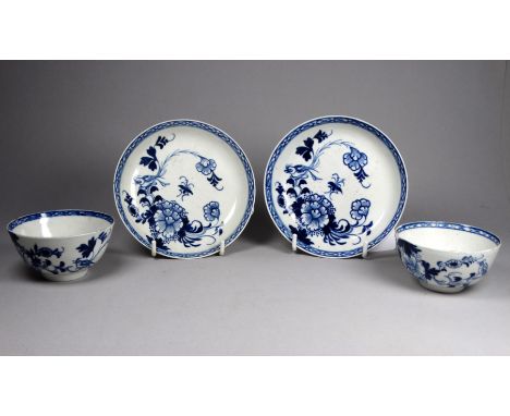 A pair of mid 18th century English blue and white tea bowls and saucers - with foliate decoration, saucer diameter 13cm.