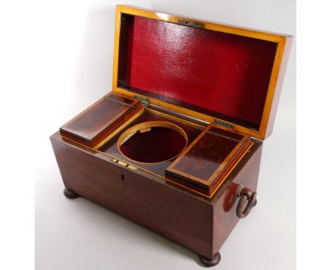An early Victorian mahogany tea caddy - of rectangular form with ring handles, the interior fitted with two caddies and apert