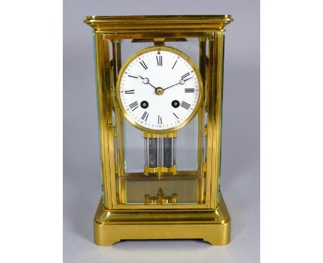 A four glass mantel clock - modelled in the form of a carriage clock, the corniche case fitted with bevelled glass panels enc