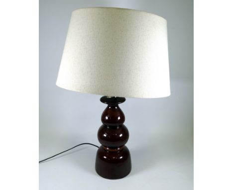 A large West German mid century pottery table lamp - of turned baluster form in a dark treacle glaze, height 59cm.