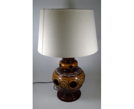 A large West German mid century pottery table lamp - of reticulated baluster form in treacle glazes, height 62cm.