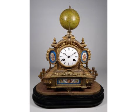 A 19th century ormolu and Sevres mounted mantel clock - surmounted by a rotating globe, the white enamel dial set out in Roma