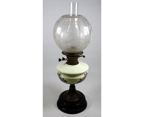 A late Victorian oil lamp - with etched clear glass globe and cream reservoir painted with flowers, on a brass stand and ebon