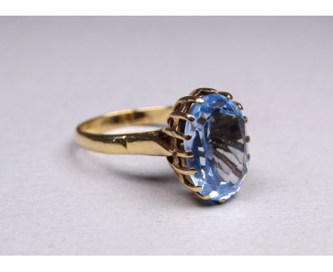 A 9ct yellow gold ring - set with an oval cut stone, possibly topaz, size P, weight 5.4g. 