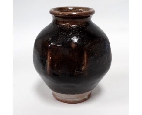 A Leach Pottery tenmoku glazed pot - of globe faceted form, indistinct impressed marks to foot rim, height 18cm. 