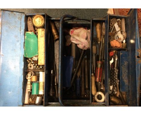 A large tin containing various tools.
