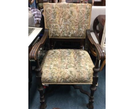 An oak carver chair with tapestry seat.