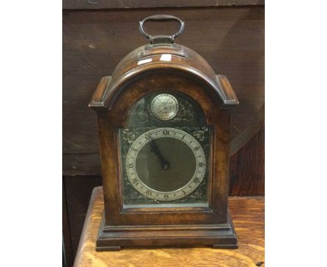 A small mahogany cased mantle clock with silvered dial.