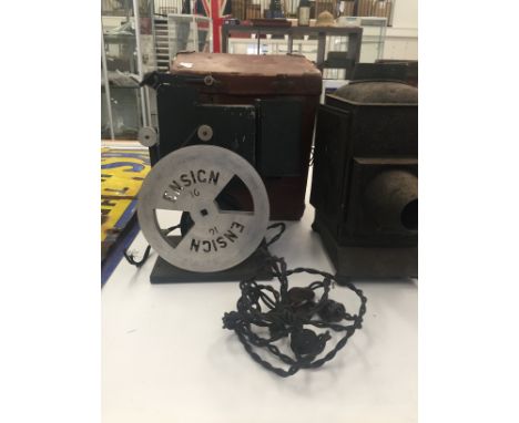 An early vintage Ensign film projector and tin