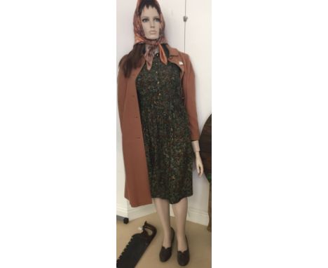 A life-size WWII female mannequin dressed in WWII attire from a wartime display