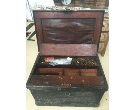 An antique village carpenter's wood chest with tools and mahogany drawers