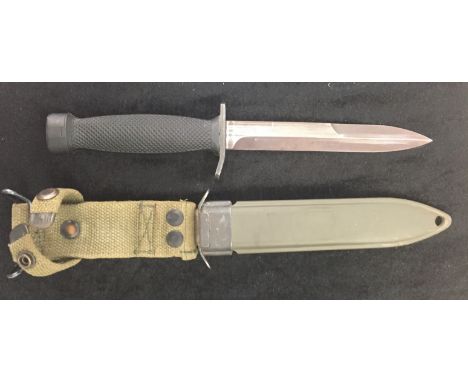 An American WWII era fighting knife in scabbard