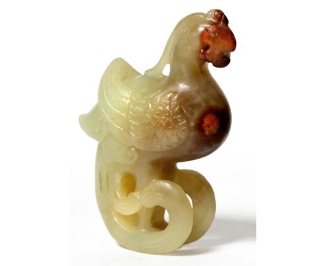 A Chinese Jade Carving of a Phoenix, Qing Dynasty, the bird stylistically carved, pale green yellow jade with iron inclusions