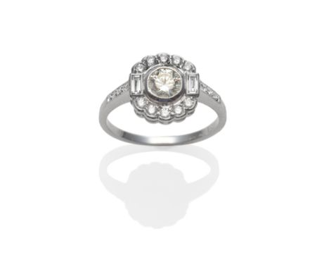 An Art Deco Style Diamond Cluster Ring, a round brilliant cut diamond centrally, spaced to a border of smaller diamonds, a ba