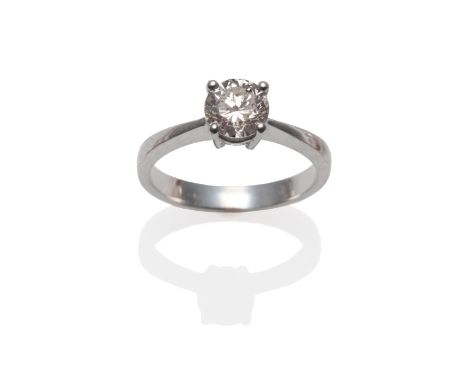 A 14 Carat Gold Diamond Solitaire Ring, the round brilliant cut diamond in a four claw setting, to a tapered shoulder plain p