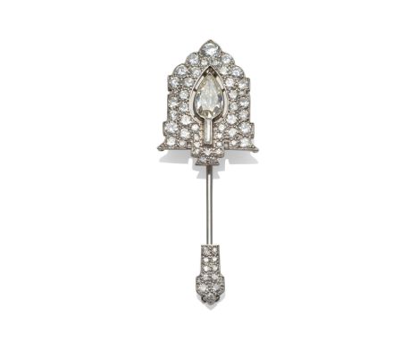 An Art Deco Diamond Jabot Pin, by Cartier, the arrow head formed of a pear cut diamond in a pierced surround to a border of a