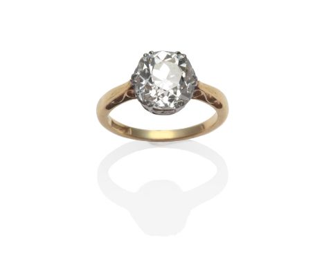 A Diamond Solitaire Ring, an old cut cut diamond, in a white claw setting, on a yellow tapered shoulder shank, estimated diam