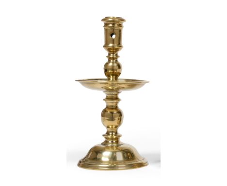 An Early 17th Century Brass Heemskerk Candlestick, the low domed foot rising to a drip tray between two ball knops, the socke