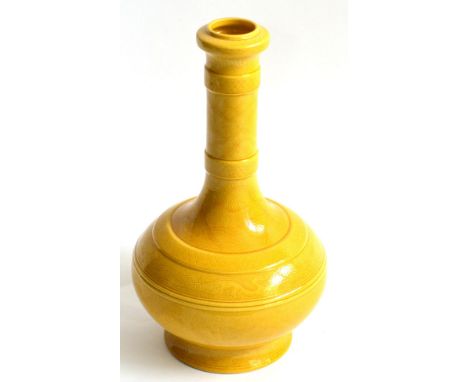 A Chinese Yellow Glazed Bottle Vase, with incised decoration of dragons, waves and cloud scrolls, Kangxi mark in blue, 27cm  