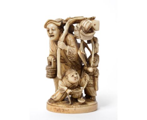 A Japanese Elephant Ivory Okimono, Meiji period (1868-1912), depicting a pedlar carrying a bucket and a branch pendant with v