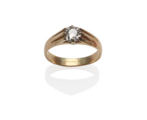 A Diamond Solitaire Ring, the old cut diamond in a yellow claw setting to forked shoulders on a plain polished shank, estimat