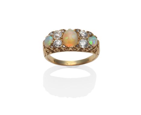 An Opal and Diamond Ring, circa 1880, the graduated oval cabochon opals spaced by pairs of old cut diamonds, in yellow claws 