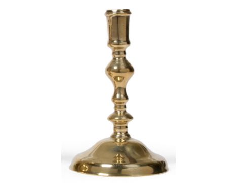 A Late 17th Century Brass Candlestick, circa 1680, on a low domed foot with an inverted baluster stem and plain socket, 19cm 