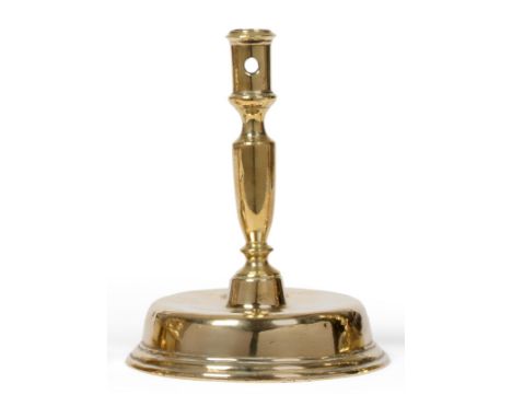 A Late 17th Century Brass Candlestick, Low Countries, circa 1680, the broad hollow domed foot with a plain set and circular a