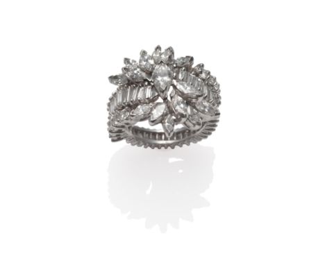 A Diamond Cluster Ring, marquise cut diamonds in a spray formation, to a twist band of baguette cut diamonds, with round bril