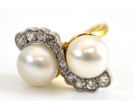 An 18 Carat Gold Cultured Pearl and Diamond Ring, the two cultured pearls in a crossover style, with old cut diamonds set wit