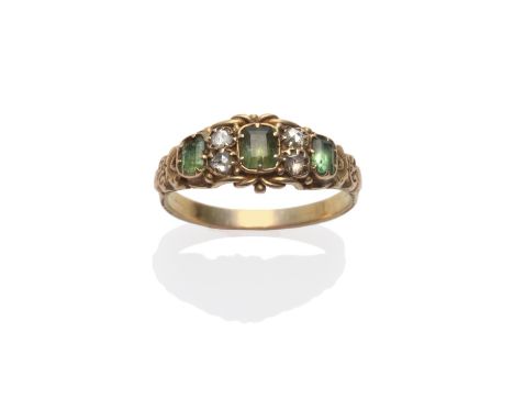 A Georgian Ring, three green step cut stones spaced by pairs of rose cut diamonds, in yellow claws within a decorative mount,