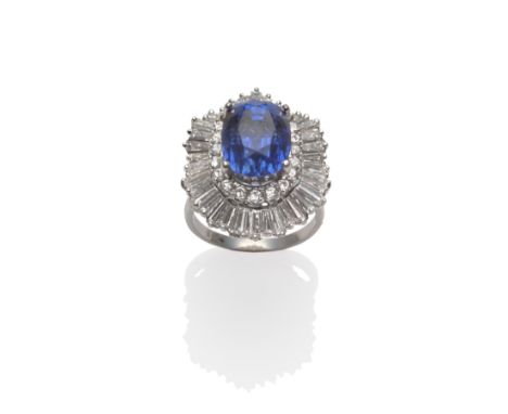 A Sapphire and Diamond Cluster Ring-dant, the oval mixed cut sapphire within a border of round brilliant cut diamonds and an 