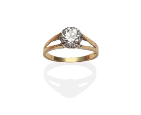 An 18 Carat Gold Diamond Solitaire Ring, the old cut diamond in a white claw setting too yellow split shoulders on a plain po
