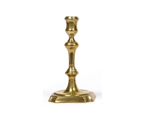 Three Early 18th Century English Brass Seamed Candlesticks, circa 1715-20, the first with a square base with re-entrant corne