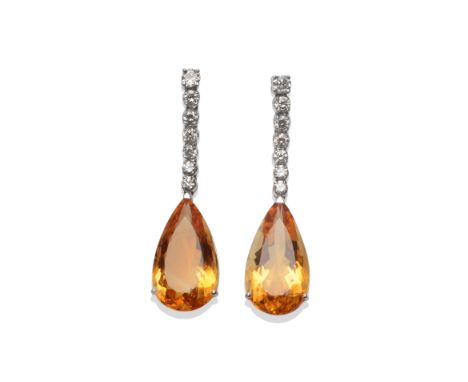 A Pair of 18 Carat White Gold Citrine and Diamond Drop Earrings, a row of round brilliant cut diamonds suspends a pear cut ci