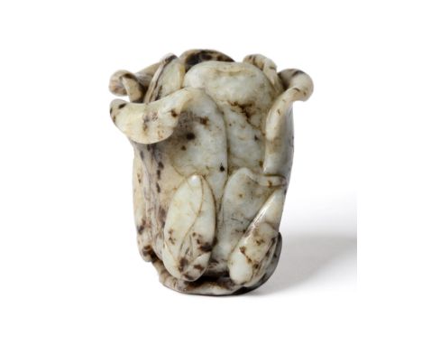 A Chinese Jade Magnolia Vase, Qing Dynasty, 18th/19th century, naturalistically modelled, the foot formed as a branch with se
