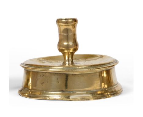 A 17th Century Brass Drum or Reel Base Candlestick, probably Spanish circa 1650, with a shallow drip tray, the socket engrave