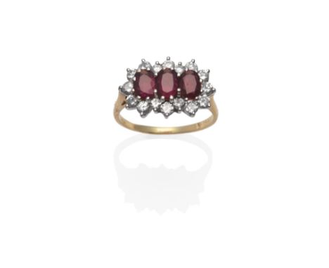 An 18 Carat Gold Ruby and Diamond Triple Cluster Ring, the oval mixed cut rubies within a border of round brilliant cut diamo