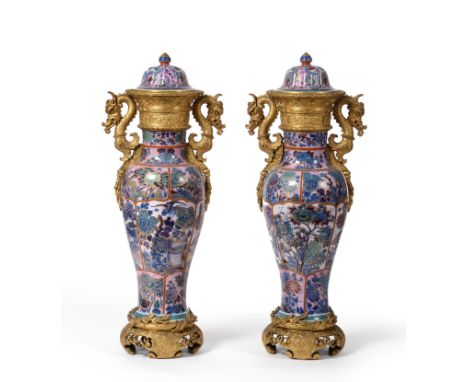 A Pair of Ormolu Mounted Chinese Porcelain Vases and Covers, early 19th century, the blue and white Kangxi vases with slightl