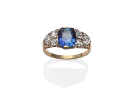 A Sapphire and Diamond Ring, an oval mixed cut sapphire with a trio of old mine cut diamonds on each shoulder, with rose cut 