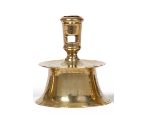 A 16th Century Brass Capstan Candlestick, probably Low Countries, 1550/80, the incurved base with a shallow drip pan and a sq