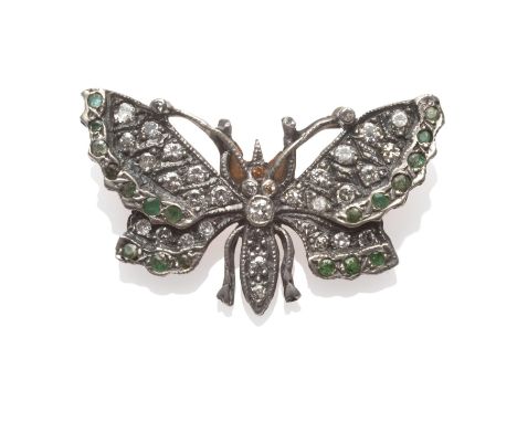 A Diamond and Emerald Butterfly Brooch, set with brilliant cut diamonds throughout, with round cut emeralds to the edges of t